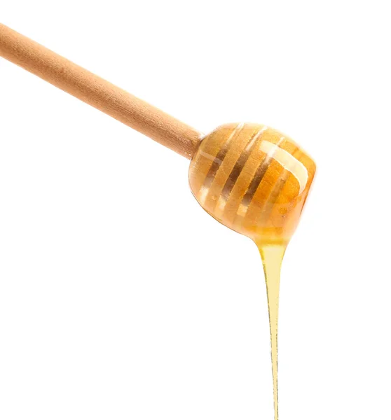 Dřevěné honey naběračka na bílém pozadí — Stock fotografie