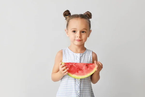 Cute little girl with slice of fresh watermelon on light background — Stock Photo, Image