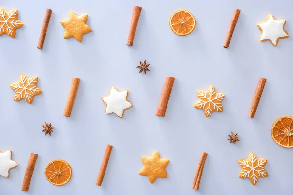 Tasty Christmas cookies, cinnamon and dry orange on light background — Stock Photo, Image