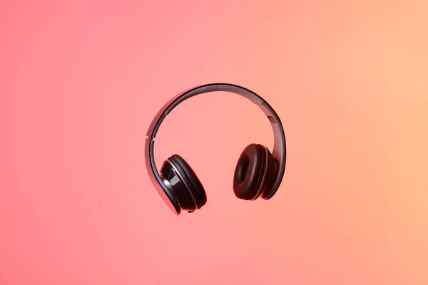 Modern headphones on color background — Stock Photo, Image