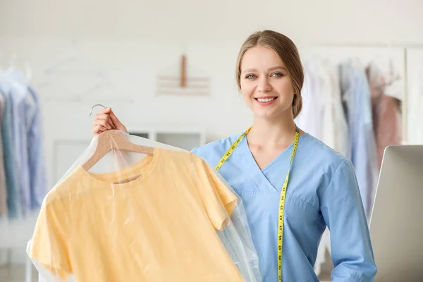 Young female worker in modern dry-cleaner's — Stock Photo, Image