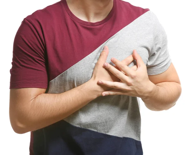 Anak muda yang menderita serangan jantung pada latar belakang putih, close-up — Stok Foto