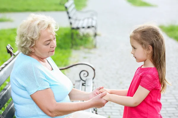 Χαριτωμένο μικρό κορίτσι με τη γιαγιά κρατώντας τα χέρια σε εξωτερικούς χώρους — Φωτογραφία Αρχείου
