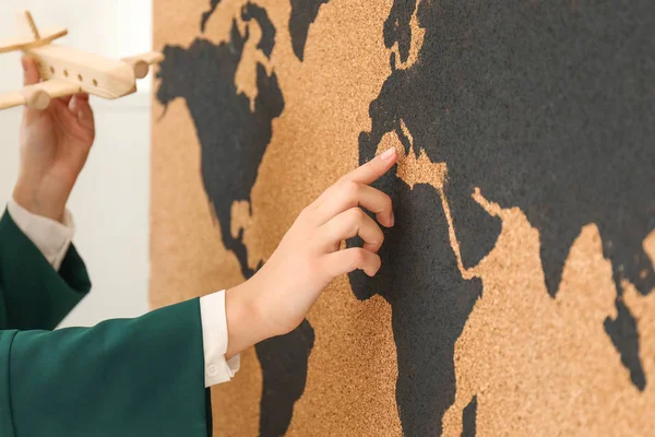 Female travel agent with airplane near map in office — Stock Photo, Image