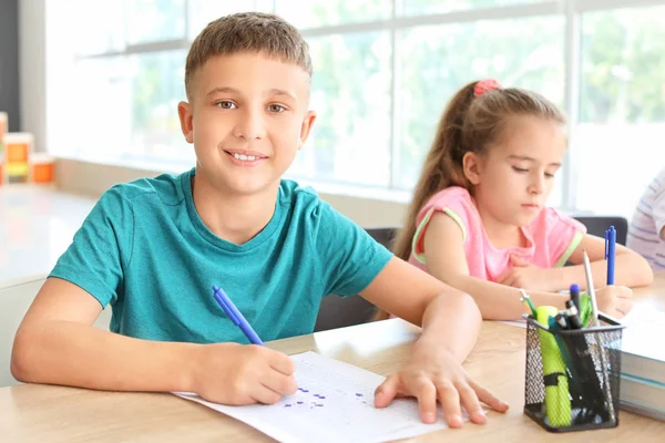 Pupils passing school test in classroom