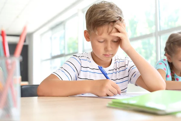 Boy passing difficult school test in classroom — Stock Photo, Image