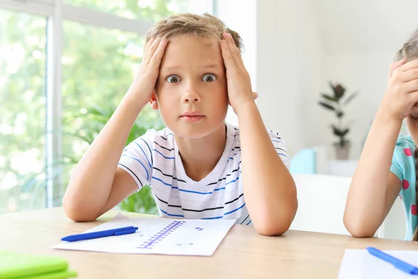 Boy passing difficult school test in classroom