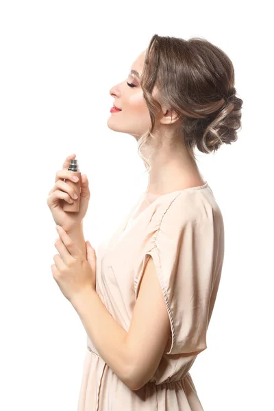 Beautiful young woman with bottle of perfume on white background — Stock Photo, Image