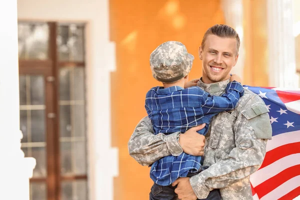 Happy military man with his son outdoors