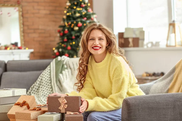 Feliz joven con regalos de Navidad en casa —  Fotos de Stock