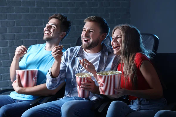 Friends with popcorn watching movie in cinema — Stock Photo, Image