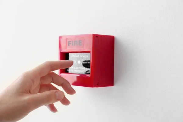 Mujer usando el punto de llamada manual del sistema de alarma de incendios — Foto de Stock