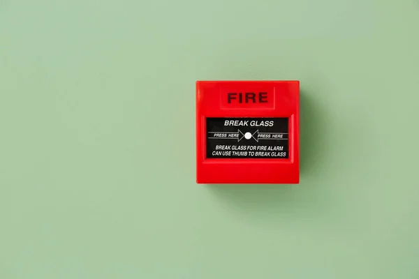 Modern manual call point of fire alarm system on color wall — Stock Photo, Image