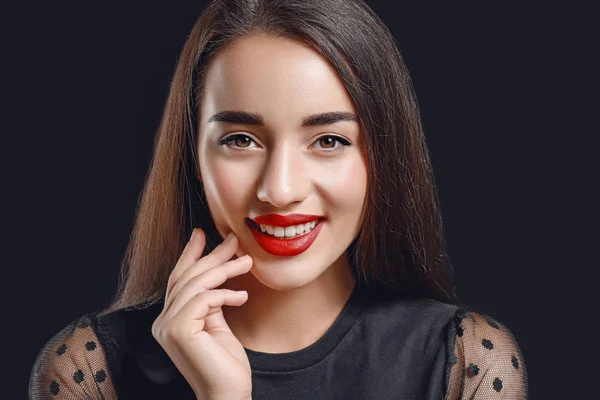 Beautiful young woman with bright lipstick on dark background — Stock Photo, Image