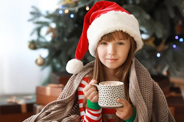 Menina bebendo chocolate quente em casa na véspera de Natal — Fotografia de Stock