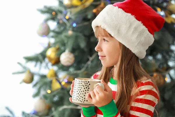 Little girl drinking hot chocolate at home on Christmas eve — Stock Photo, Image
