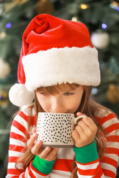 Little girl drinking hot chocolate at home on Christmas eve — Stock Photo, Image