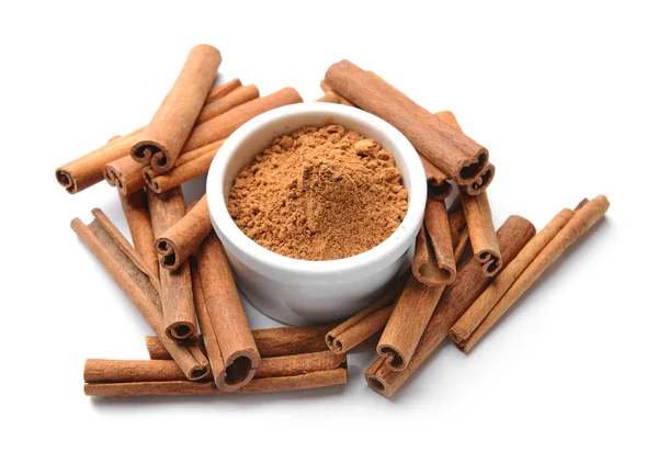 Aromatic cinnamon sticks and powder on white background — Stock Photo, Image