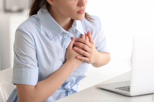 Young woman suffering from heart attack at home — Stock Photo, Image