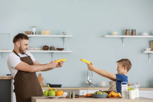 Portrait of father and son having fun while cooking in kitchen — Stock Photo, Image