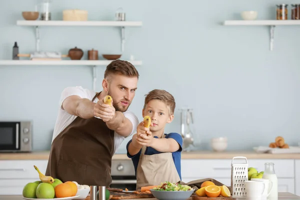 Portrait of father and son having fun while cooking in kitchen — Stock Photo, Image