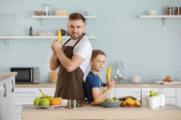 Portrait of father and son having fun while cooking in kitchen — Stock Photo, Image