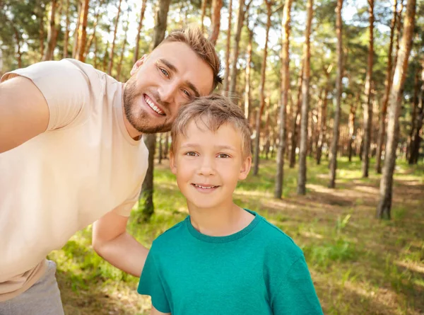 Padre e suo figlio si fanno selfie nella foresta — Foto Stock