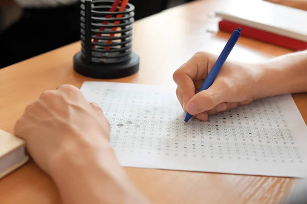 Teenage girl passing school test in classroom — Stock Photo, Image