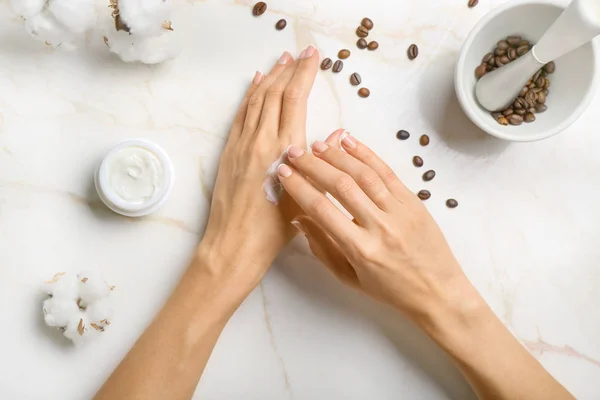 Female hands with natural cream on light background — Stock Photo, Image