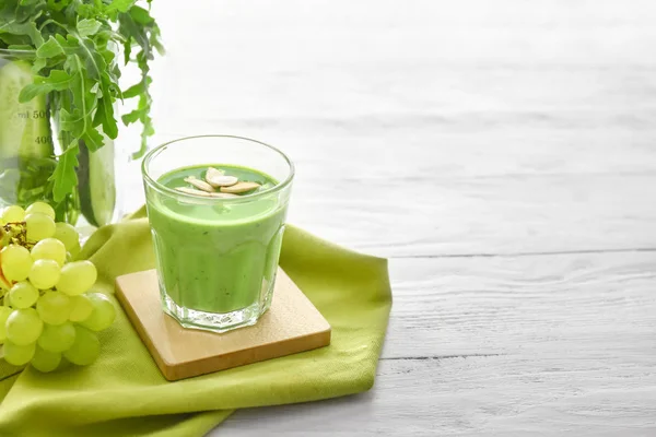 Glass of healthy smoothie with ingredients on white table — Stock Photo, Image