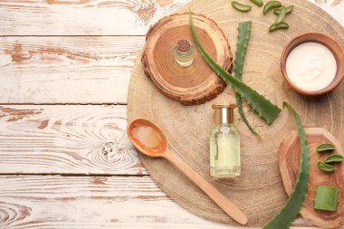 Beyaz ahşap arka plan üzerinde aloe yaprakları ile Kozmetik ürünler