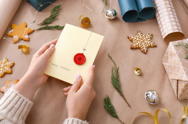 Woman with creative Christmas card at table — Stock Photo, Image