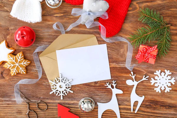 Empty card with envelope and Christmas decor on wooden background — Stock Photo, Image