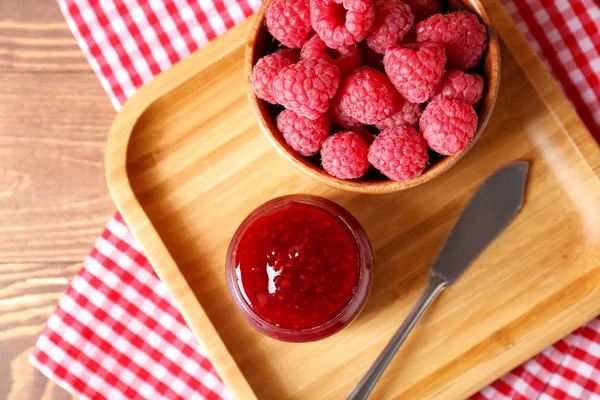 Tasty raspberry jam on wooden table — Stock Photo, Image