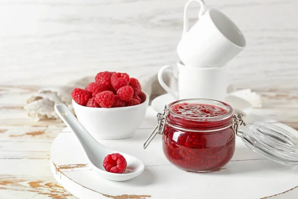 Tasty raspberry jam on white wooden table — Stock Photo, Image