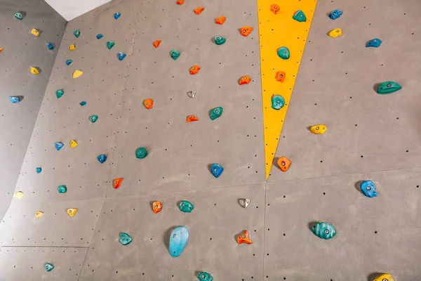 Wall with climbing holds in gym