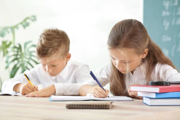 Little pupils doing lessons in classroom — Stock Photo, Image