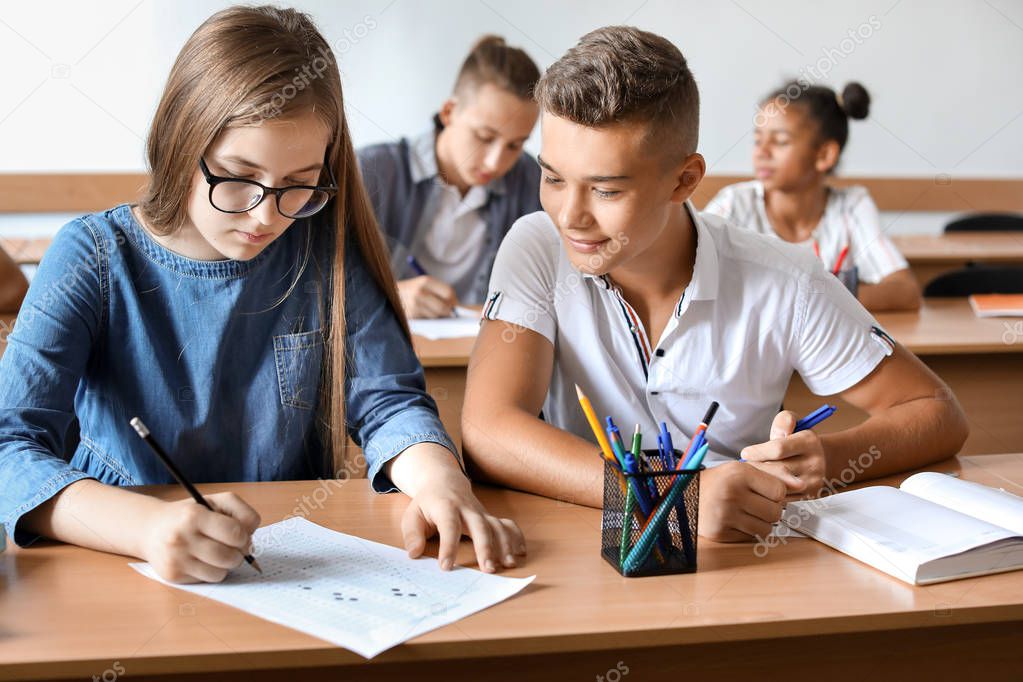 Boy cheating during school test in classroom