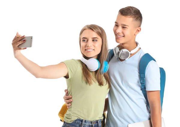 Portrait of young students taking selfie on white background — Stock Photo, Image