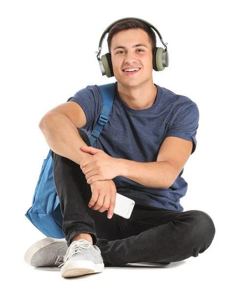 Portrait of young student with headphones on white background — Stock Photo, Image