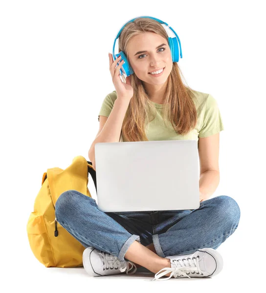 Portrait of young student with laptop and headphones on white background — Stock Photo, Image