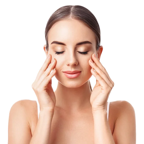 Beautiful woman massaging her face against white background — Stock Photo, Image