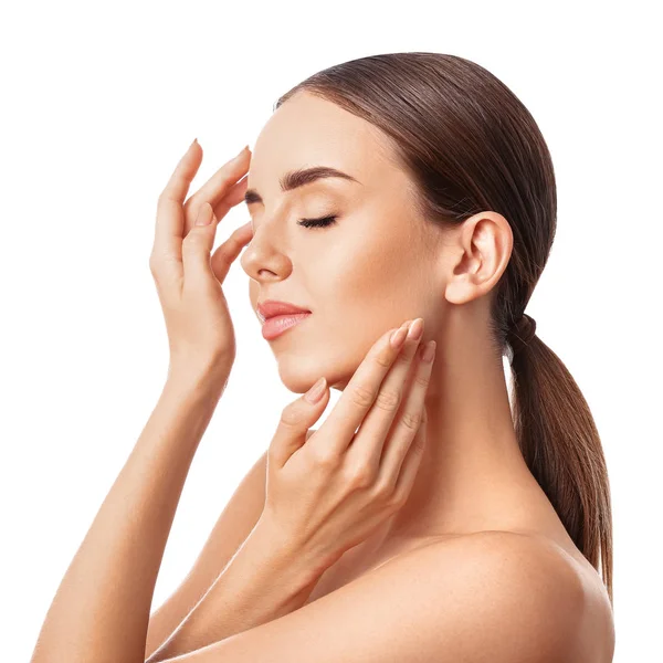 Beautiful woman massaging her face against white background — Stock Photo, Image