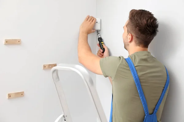 Electrician installing alarm system indoors — Stock Photo, Image