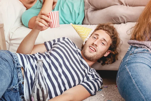 Young man with hangover after party at home — Stock Photo, Image