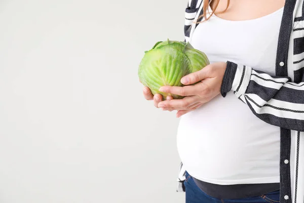 Beautiful pregnant woman with cabbage on white background — Stock Photo, Image