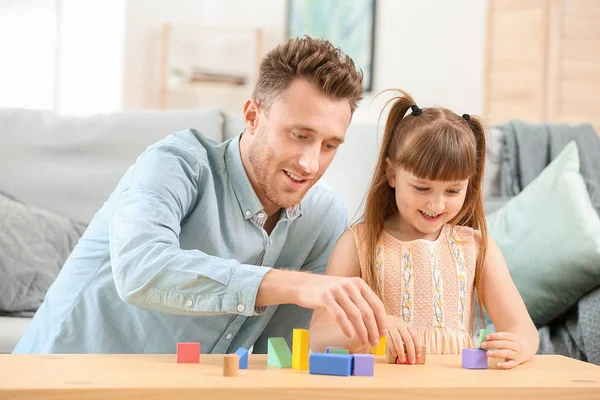 Portrait of happy father and his little daughter playing at home — Stock Photo, Image