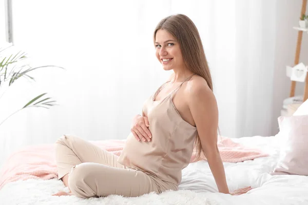 Ráno krásná těhotná žena v ložnici — Stock fotografie