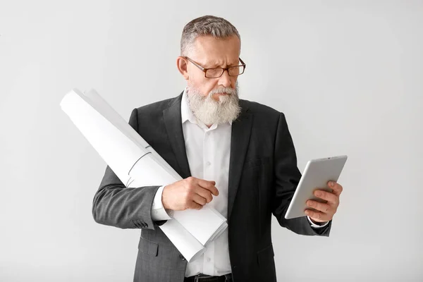 Mature male architect with tablet computer on white background — Stock Photo, Image