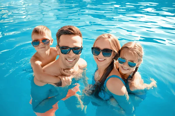 Szczęśliwa rodzina w basenie w dniu letnim — Zdjęcie stockowe